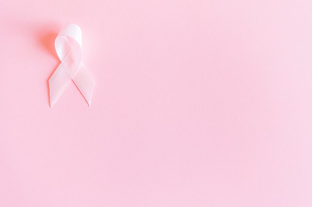 pink ribbon on pink background. 