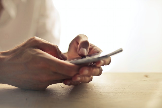A close-up of woman's hands holding a smartphone. 